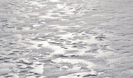 Frozen hard-packed snow, glistening in the sunshine. 