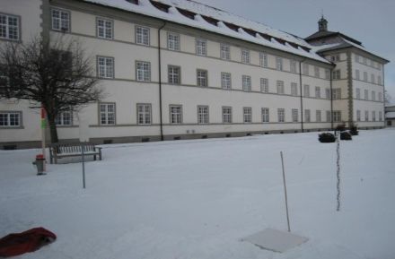 A snowboard for measuring new snowfall and a snow-gauge pole for measuring the total snow depth.