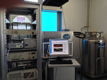 Illustration showing the microwave radiometer SOMORA in Payerne. The quasi-optical detection system of the microwave radiation is located behind the screen of the computer (inside the grey box) and measures through the blue window, which is highly transparent at microwave wavelengths.