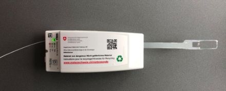 Image of a radiosonde in a white plastic casing.