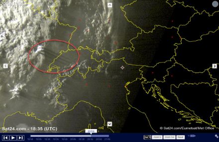 A satellite image showing a few cumulus clouds and the shadows that they cast into the atmosphere.