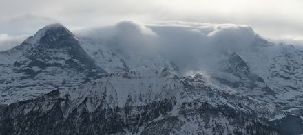 View from the Schynige Platte to the Bernese Oberland trio of Eiger, Mönch and Jungfrau, taken during Guggifoehn conditions. The webcam image clearly shows the foehn wall. In the foreground, snow plumes can be seen on the Lauberhorn.