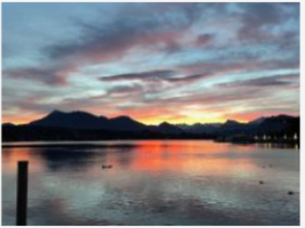 Sunrise with mountains and lake.